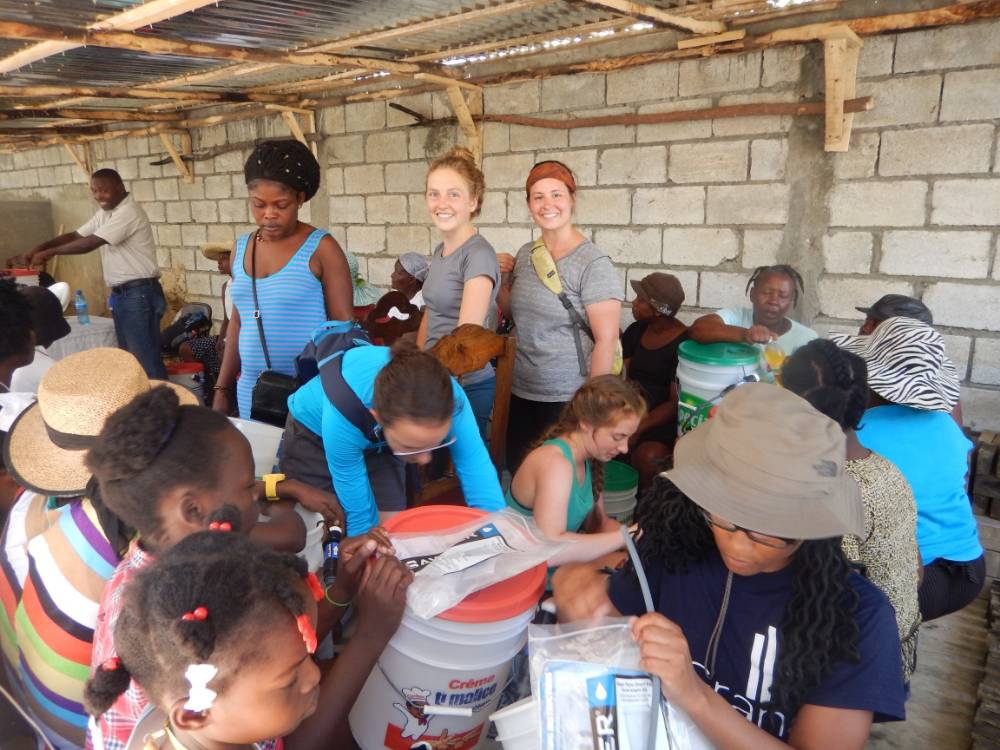 Madalyn Slubowksi, Anna Vander Boon, and MacKenzie Kraft helping build and distribute water filters near Borel, Haiti